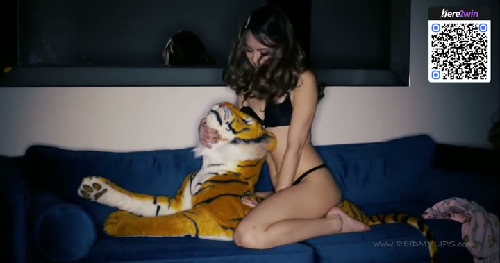 Watch A solo female adult with inborn hooters relaxes on a blue velvet sofa while hugging a tiger plushie